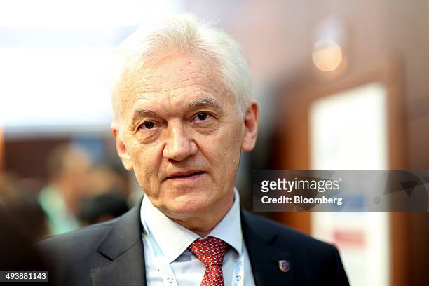 Russian billionaire Gennady Timchenko pauses while speaking to reporters as he exits a session titled "Russia-China: Strategic Economic Partnership...