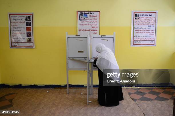 An Egyptian woman casts her ballot at a polling station during the Egypt's presidential election in the Shubra district of Cairo, Egypt on May 26,...