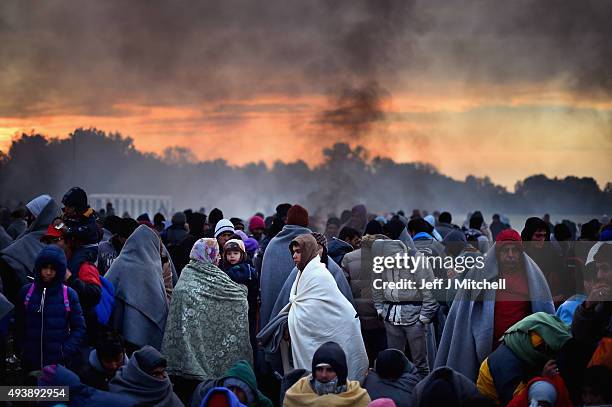 Migrants are held back by the police near the village of Rigonce,before being walked to Brezice refugee camp on October 23, 2015 in Rigonce,...