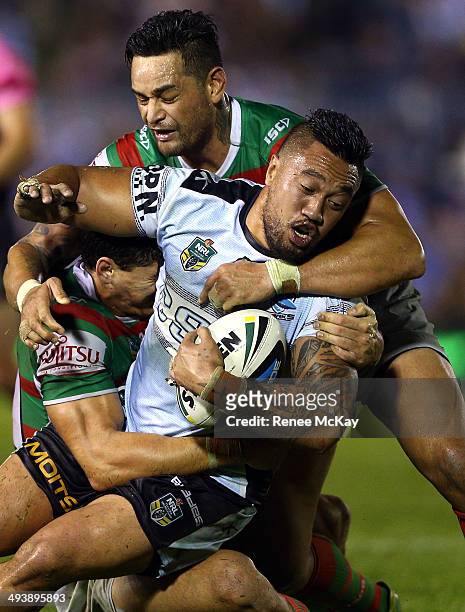 Tinirau Arona of the Sharks is tackled by Kyle Turner and John Sutton during the round 11 NRL match between the Cronulla-Sutherland Sharks and the...