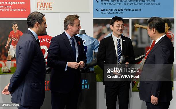 China's President Xi Jinping and Britain's Prime Minister David Cameron are introduced to former Manchester City player Sun Jihai by Manchester City...