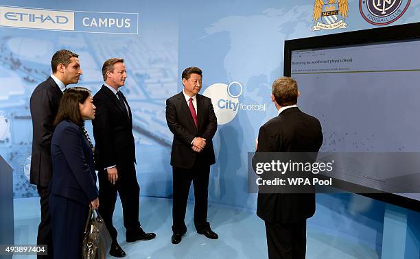 China's President Xi Jinping and Britain's Prime Minister David Cameron are given a demonstration on player monitoring and recruitment with...