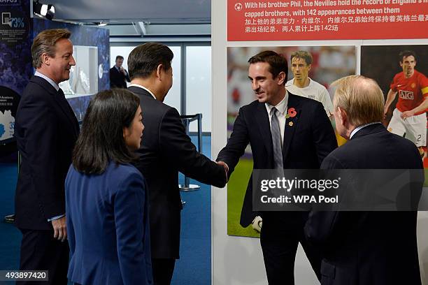 China's President Xi Jinping and Britain's Prime Minister David Cameron meet former Manchester United player Gary Neville during a visit to the City...