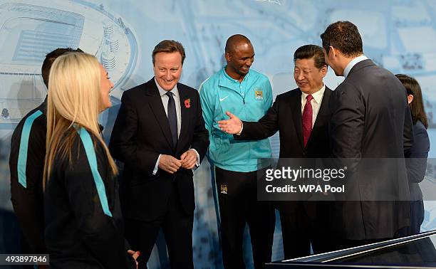 China's President Xi Jinping and Britain's Prime Minister David Cameron meet Manchester City's Sergio Kun Aguero , Manchester City Women's Toni...