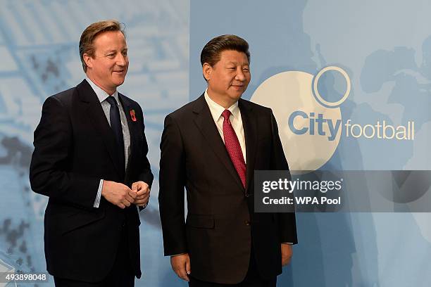 Britain's Prime Minister David Cameron and China's President Xi Jinping during a visit to the City Football Academy on October 23, 2015 in...