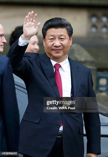 China's President Xi Jinping waves as he arrives for lunch with Britain's Prime Minister David Cameron at Manchester Town Hall on October 23, 2015 in...