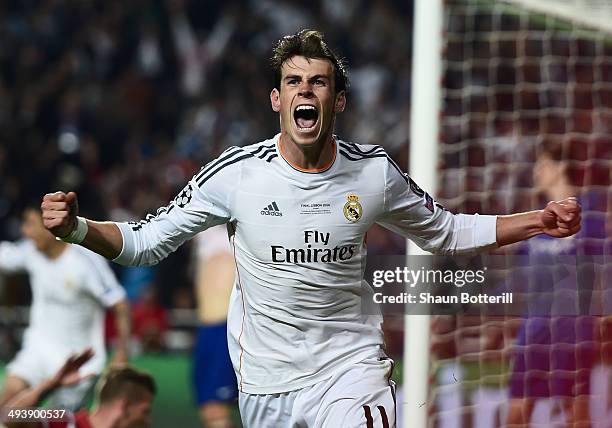 Gareth Bale of Real Madrid celebrates scoring their second goal in extra time during the UEFA Champions League Final between Real Madrid and Atletico...