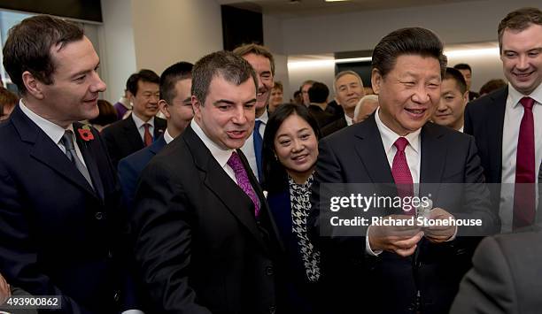 The President of the People's Republic of China Xi Jinping is presented with a miniature figurine of himself and his wife created by a 3D digital...