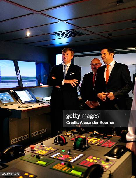 King Willem-Alexander of The Netherlands is given a tour of a general cargo vessel simulator together with Minister of Economy of the State of Lower...