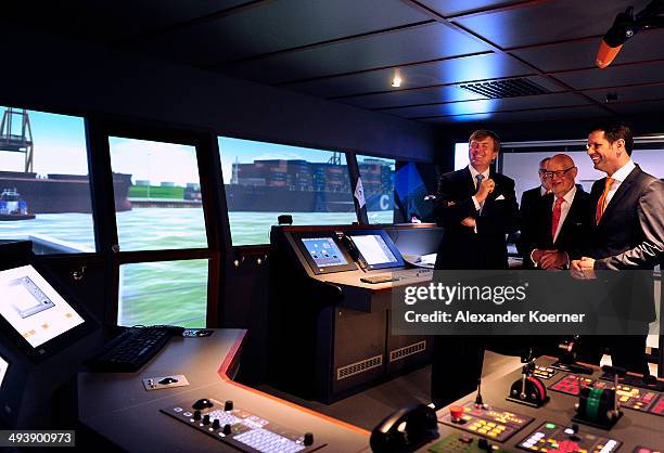 King Willem-Alexander of The Netherlands is given a tour of a general cargo vessel simulator together with Minister of Economy of the State of Lower...