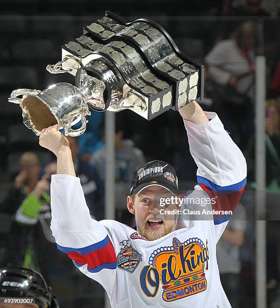 Henrik Samuelsson of the Edmonton Oil Kings hoists the MasterCard Memorial Cup after defeating the Guelph Storm in the final of the 2014 MasterCard...