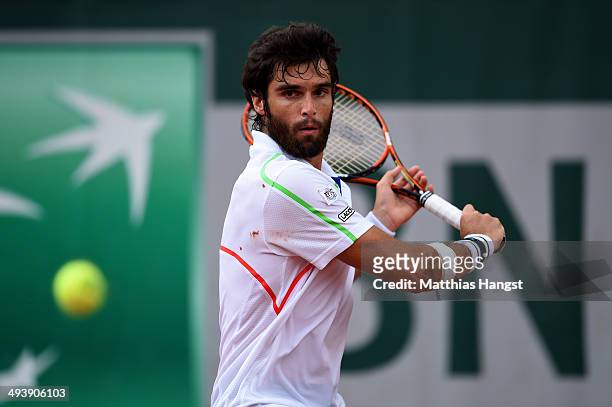 Pablo Andujar of Spain returns a shot during his men's singles match against Marin Cilic of Croatia on day two of the French Open at Roland Garros on...