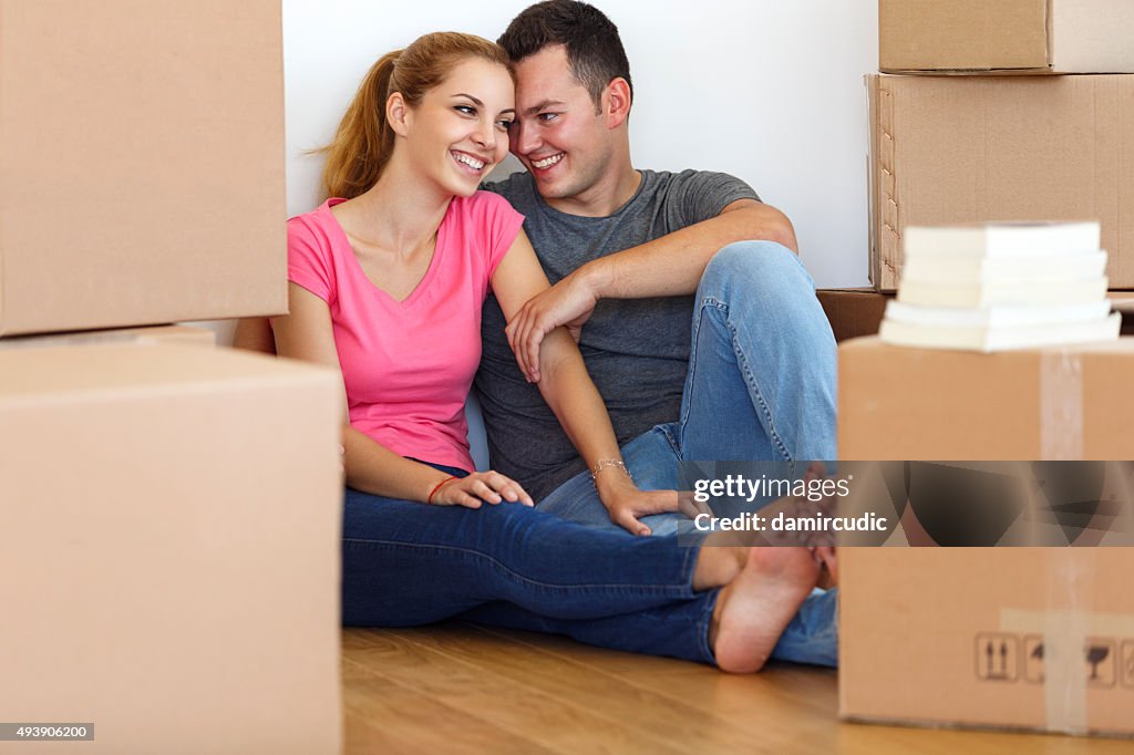 Young couple resting from moving into a new  home