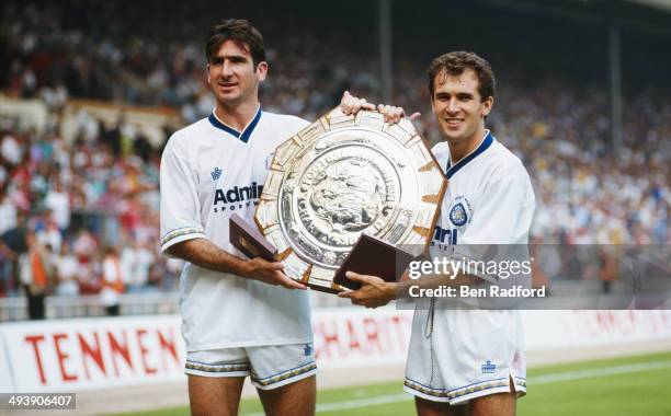 Leeds United goalscorers Eric Cantona and Tony Dorigo pose with the trophy after the FA Charity Shield between Leeds United and Liverpool at Wembley...