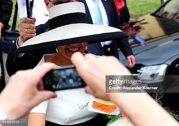 Queen Maxima of the Nethlerands is pictured cheering to the public while leaving the AUDI eGas research facility on May 26, 2014 in Werlte, Germany....