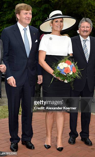 King Willem-Alexander of the Netherlands and Queen Maxima are pictured while leaving the AUDI eGas research facility on May 26, 2014 in Werlte,...