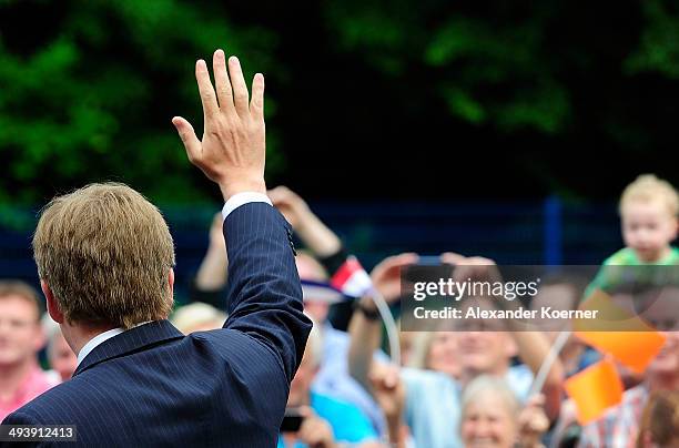 King Willem-Alexander of the Netherlands is pictured while cheering to the public while leaving the AUDI eGas research facility on May 26, 2014 in...