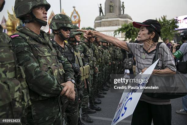 Thai protester points a finger at the Thai military during an anti-coup protests as General Prayuth receives the Royal Endorsement as the military...