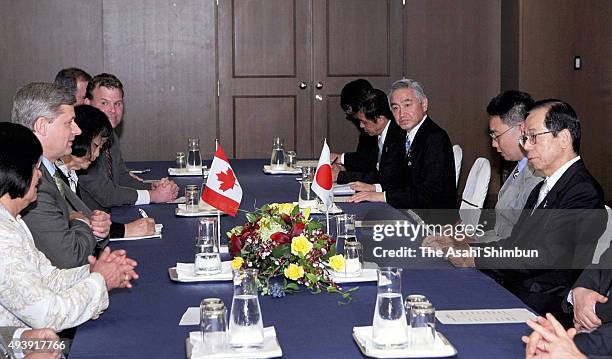 Canadian Prime Minister Stephen Harper and Japanese Prime Minister Yasuo Fukuda talk during their meeting on the sidelines of the G8 Summit on July...