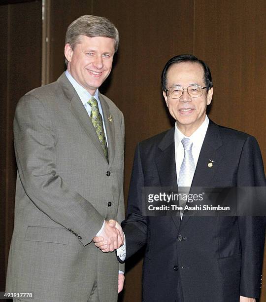 Canadian Prime Minister Stephen Harper and Japanese Prime Minister Yasuo Fukuda shkae hands during their meeting on the sidelines of the G8 Summit on...
