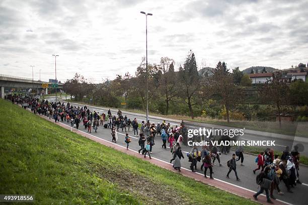 Refugees and migrants walk on a road as they leave Sentilj, Slovenia, on their way to cross the Slovenian-Austrian border on October 23, 2015. Some...