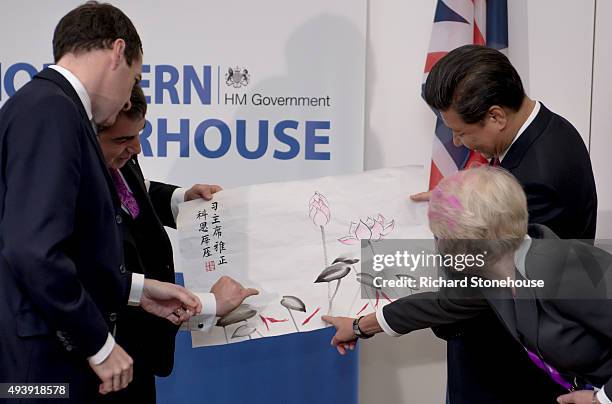 The President of the People's Republic of China Xi Jinping presents a gift of paint brushes and an ink painting made using Graphine ink to Professor...