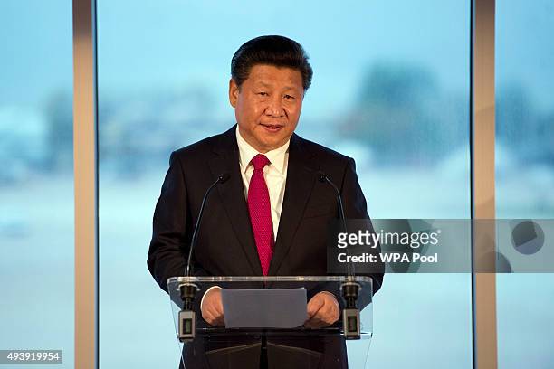 China's President Xi Jinping addresses an audience of dignitaries including the British Prime Minister David Cameron at Manchester airport on October...