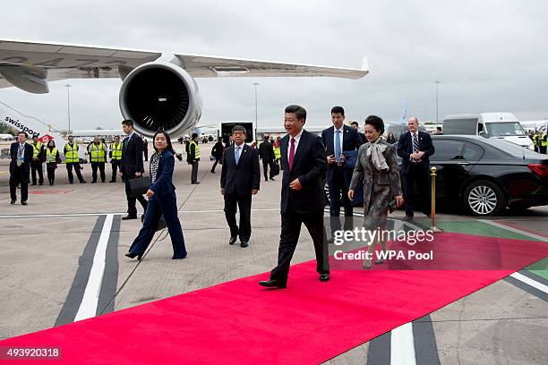 China's President Xi Jinping and his wife Peng Liyuan arrive to board an Air China plane at Manchester airport on October 23, 2015 in Manchester,...