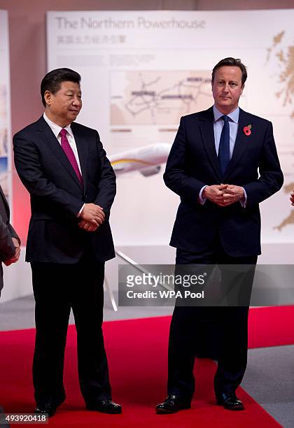 China's President Xi Jinping and British Prime Minister David Cameron tour an exhibition of future developments at Manchester airport on October 23,...