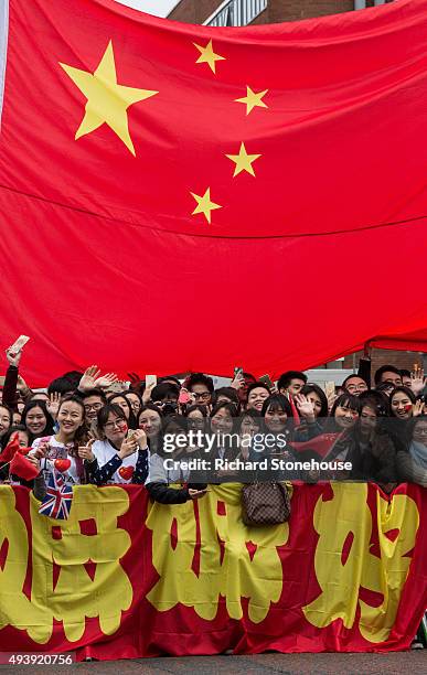 Chinese students show support for the President of the People's Republic of China Xi Jinping as he arrives to tour the National Graphene Institute at...