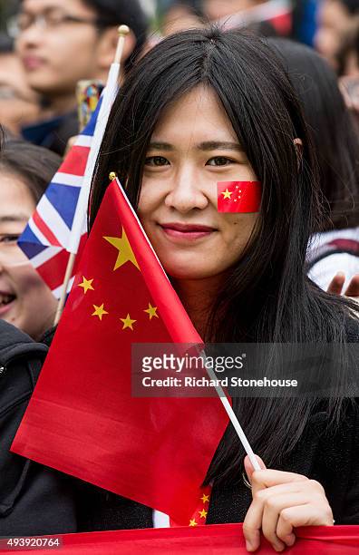 Chinese students show support for the President of the People's Republic of China Xi Jinping as he arrives to tour the National Graphene Institute at...