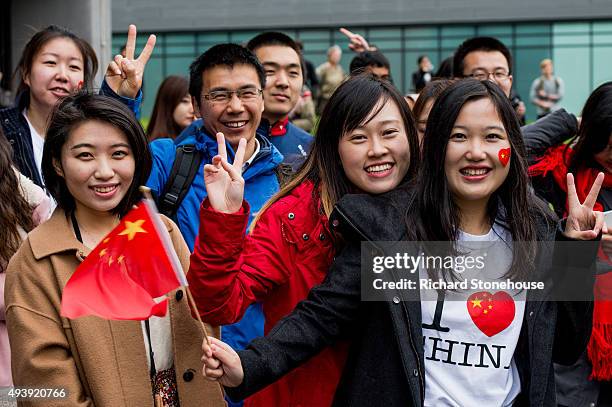 Chinese students show support for the President of the People's Republic of China Xi Jinping as he arrives to tour the National Graphene Institute at...