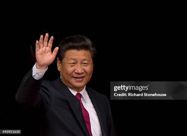 President Xi Jinping waves as he visits Manchester Town Hall on October 23, 2015 in Manchester, England. After listening to a presentation from Dame...