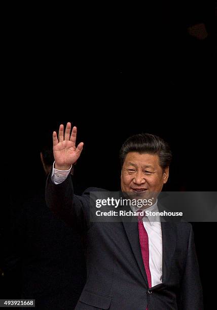 President Xi Jinping waves as he visits Manchester Town Hall on October 23, 2015 in Manchester, England. After listening to a presentation from Dame...