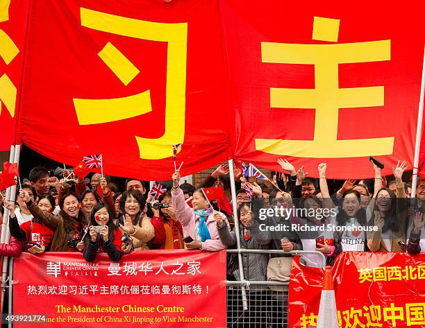 Chinese students show support for the President of the People's Republic of China Xi Jinping as he arrives at Manchester Town Hall on October 23,...