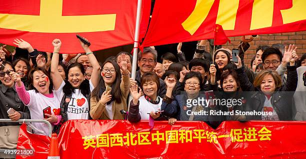Chinese students show support for the President of the People's Republic of China Xi Jinping as he arrives at Manchester Town Hall on October 23,...