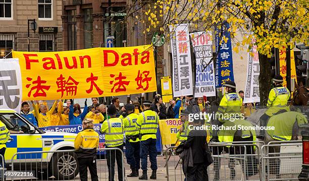 Protestors wait for the President of the People's Republic of China Xi Jinping as he visits Manchester Town Hall on October 23, 2015 in Manchester,...