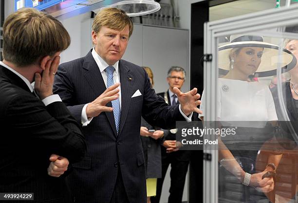 Dutch King Willem-Alexander talks to the institute's director Carsten Agert during their visit of the EWE research center's laboratory 'Next Energy'...