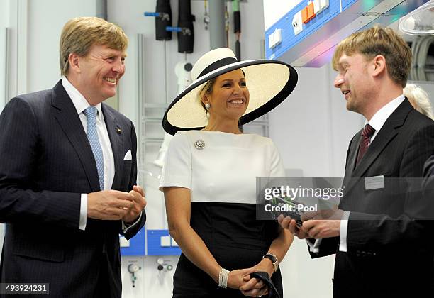 Dutch King Willem-Alexander and Dutch Queen Maxima talk to the institute's director Carsten Agert during their visit of the EWE research center's...