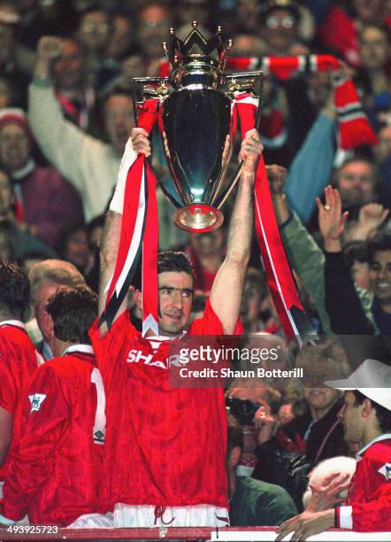 Manchester United player Eric Cantona lifts the FA Premier League trophy as United celebrate being the first winners of the FA Premier League for the...
