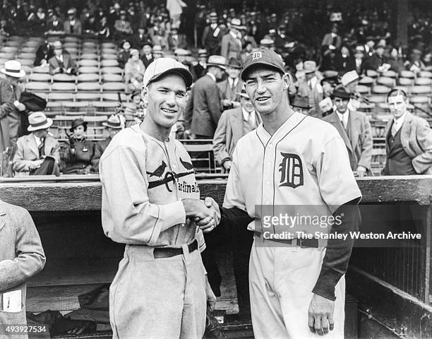 Dizzy Dean of the St. Louis Cardinals and Schoolboy Rowe of the Detroit Tigers shake hands before Game 1 of the 1934 World Series at Navin Field on...