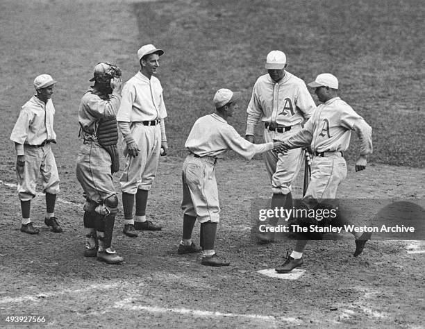 Jimmy Foxx of the Philadelphia Athletics is congratulated after hitting a home run during Game 4 of the 1931 World Series against the St. Louis...