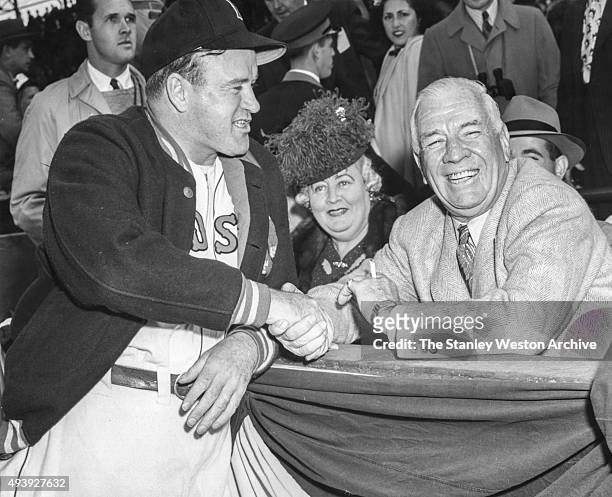 Tris Speaker wishes good luck to manager Joe Cronin of the Boston Red Sox before Game 3 of the 1946 World Series against the St. Louis Cardinals at...