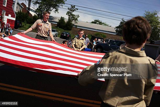 Boy Scouts carry an American Flag in the annual Memorial Day Parade on May 26, 2014 in Fairfield, Connecticut. Across America towns and cities will...