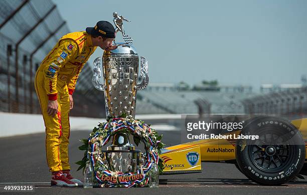 Ryan Hunter-Reay driver of the Andretti Autosport Dallara Honda kisses the Borg Warner Trophy at the yard of bricks during the Indianapolis 500 Mile...