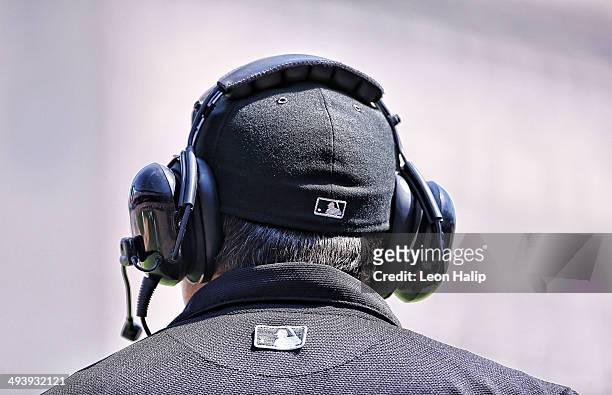 Major League Umpire Ron Kulpa puts on the head set to New York during a official review during the game between the Detroit Tigers and the Texas...