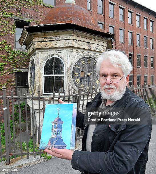 Historian George Collord shows a photo of the original condition of the clock tower taken down from the top of the Lincoln Mill that he plans on...