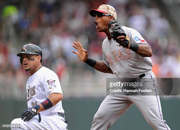 Adrian Beltre of the Texas Rangers reacts as Oswaldo Arcia of the Minnesota Twins is called safe at third base during the first inning of the game on...