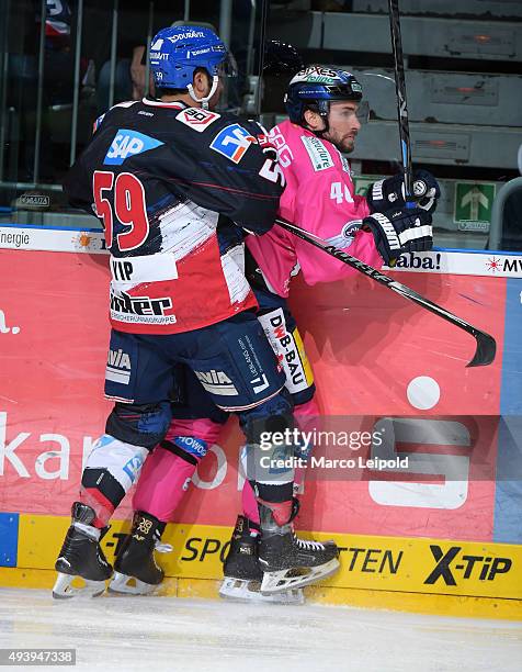 Brandon Yip of the Adler Mannheim and Darin Olver of the Eisbaeren Berlin during the game between the Adler Mannheim and the Eisbaeren Berlin on...