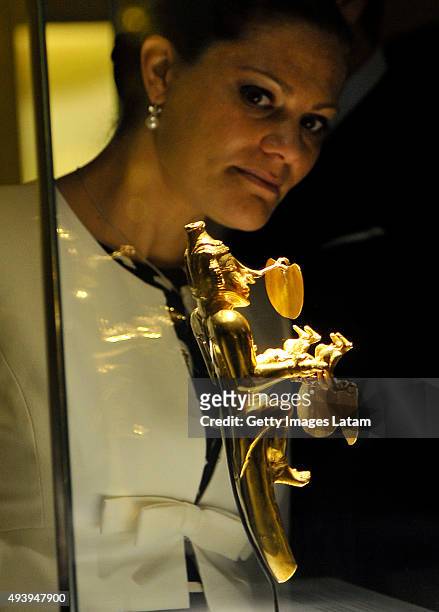 Crown Princess Victoria of Sweden looks at a prehispanic gold piece during a visit to the Gold Museum on October 23, 2015 in Bogota, Colombia.
